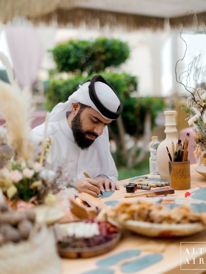 We included live artisans, like this calligrapher, to make the 'Markets of the Middle East' theme truly immersive and interactive for guests, celebrating the beauty of local crafts and culture.