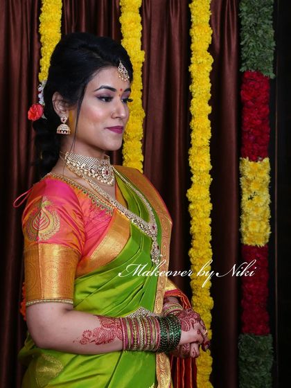 Nirosha looking absolutely radiant for her engagement. We went with a classic South Indian look, featuring a defined eye, a warm lip color, and a simple updo that perfectly complemented her green and pink silk saree.