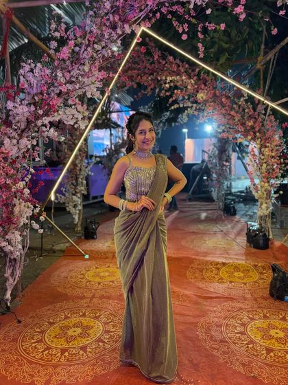 Glow in this stunning green shimmer ready-to-wear saree. The fully sequined blouse and pre-draped silhouette make it a glamorous and convenient choice for an evening reception or cocktail party.