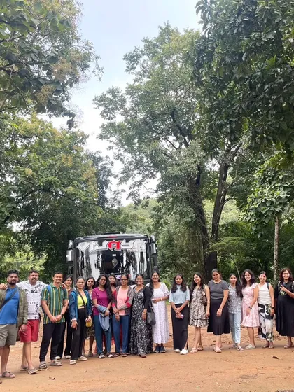 Our group posing with the bus before heading into the forest for the Dudhsagar Falls trek. We provide comfortable transport from Bengaluru.