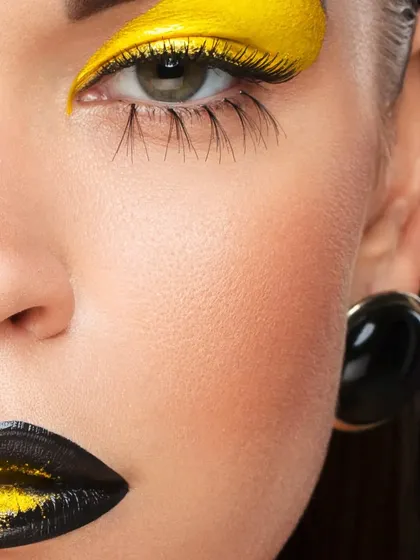 A cropped version of the yellow and black beauty look, focusing on the eye makeup. This composition creates an artistic and intense feel, suitable for a fashion editorial.
