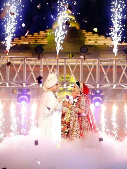 Anmol and Deepali's varmala moment, enveloped in a cloud of smoke and sparkling pyrotechnics. We use special effects to elevate key moments, making them feel truly magical and cinematic.