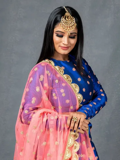 This shot highlights the beautiful detailing on the outfit and jewelry I provided, along with the elegant makeup.