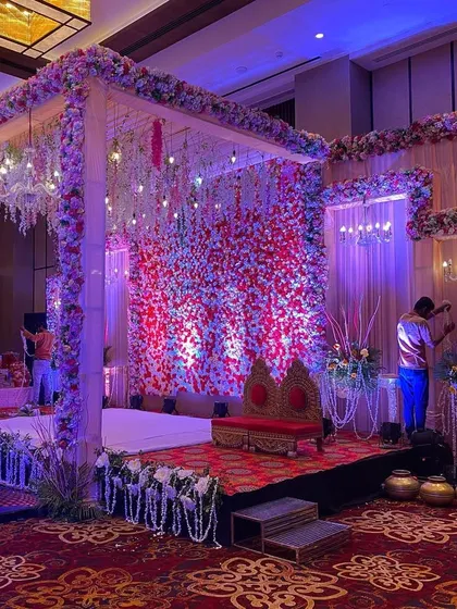 A wider view of the indoor floral stage, showing the complete setup with seating and side decor.