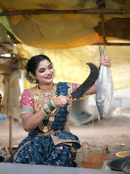 Getting hands-on in the market. This shot, with the fish and the sickle, adds a touch of realism to our Koli-themed shoot.