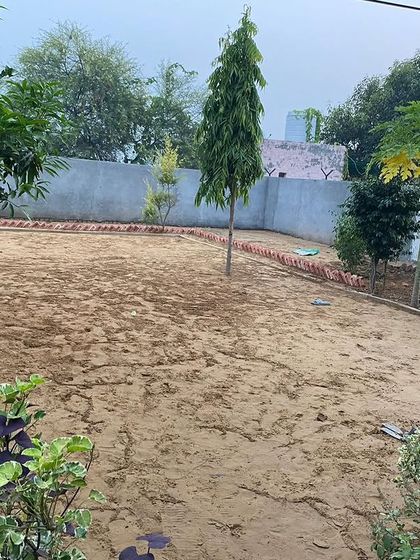 A bare patch of land at a farmhouse, just waiting to be turned into a beautiful lawn.