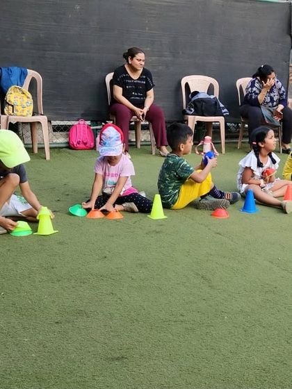 Even when taking a short break, the kids are engaged. Here, they are using the cones for a stacking game, which is great for fine motor skills. We love seeing parents watch their kids learn and play.