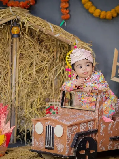 A cool and confident pose from our little Lohri star, leaning against his jeep. A fun and modern take on a traditional festival shoot.