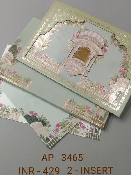 This pastel green invitation features a beautiful laser-cut arch with gold foil details. The matching inserts are adorned with floral and elephant motifs for a complete traditional look.