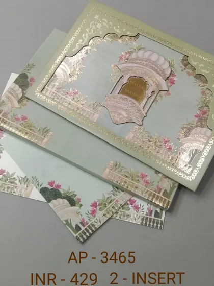 This pastel green invitation features a beautiful laser-cut arch with gold foil details. The matching inserts are adorned with floral and elephant motifs for a complete traditional look.
