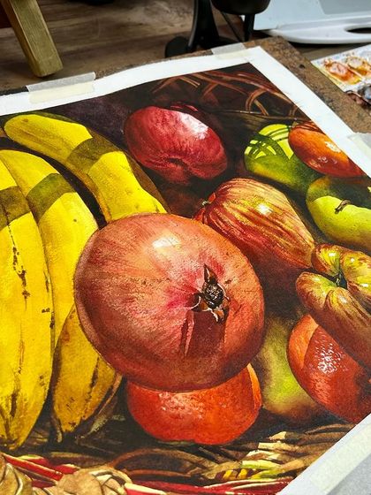 A close-up of the fruit basket painting, showing the details of the pomegranate and bananas.