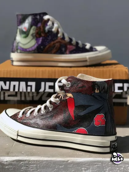 A stacked view of our Naruto themed Converse high-tops. This angle shows both the Orochimaru and Itachi designs, highlighting the contrast between the cosmic purple and the dark red Akatsuki theme.