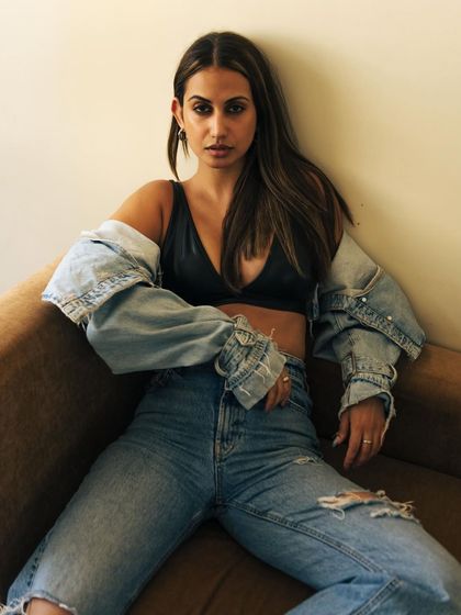 A relaxed, cool-girl pose on a couch with natural light. This shows a model's ability to look effortless and chic.
