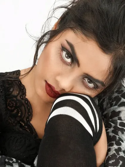 An edgy look defined by a thick, sharp winged liner and a deep red lip. This classic combination is executed with precision for a bold and impactful result.