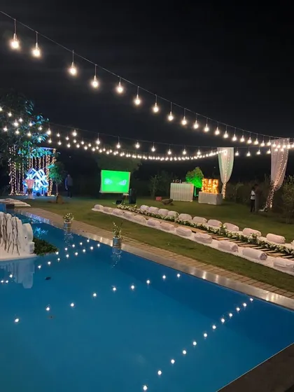 We cater events of all sizes, including this stunning private pool party at a farmhouse in Nashik. This view shows our ability to create a magical ambiance with lighting and strategic food station placement for large-scale destination events.