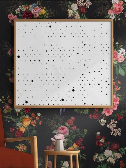 A creative use of the floral wallpaper, where it acts as a frame for a piece of modern, minimalist art.