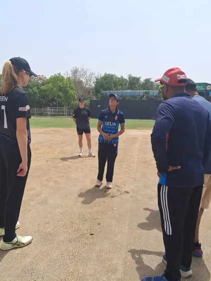 We provide exposure to the highest levels of the game. Here, our City Cricket Academy Women's Team is in a strategy discussion during a competitive match against the visiting New Zealand Caps team.