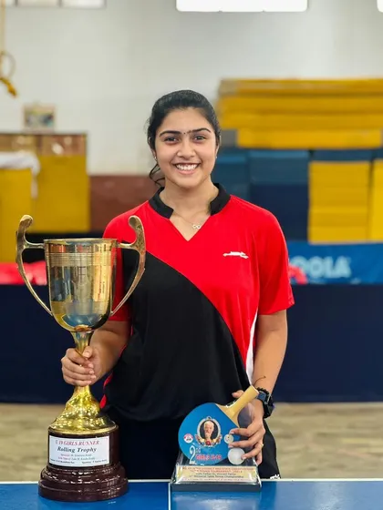 Charvi proudly holds her trophy after securing 2nd place in the Under 19 girls singles event at the Andhra Pradesh state championship.