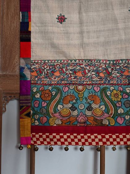 A close-up of the runner, showing the hand-painted Madhubani peacock panel and the intricate border details.