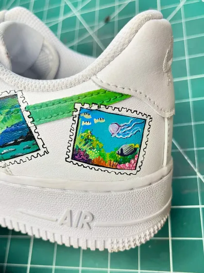 Another detail shot of the stamp-themed AF1s, featuring a colorful coral reef scene.
