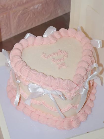 The perfect heart-shaped cake for a 22nd birthday, combining vintage piping techniques with a modern, clean aesthetic.