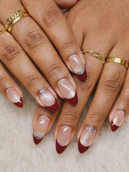 A trendy combination of a deep red French tip with a soft, white cat-eye base. I added a touch of sparkle along the cuticle for an effortlessly luxurious finish.