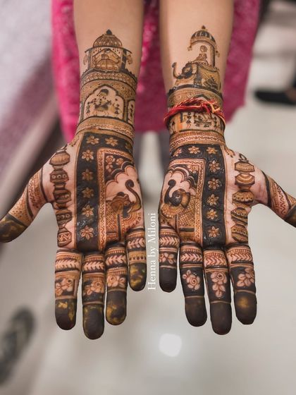A heavy design for the groom's mother, featuring traditional motifs like the 'kalash' and elephants in a procession, symbolizing blessings and prosperity.