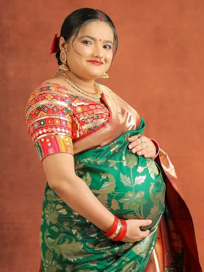 This portrait showcases the stunning detail of the embroidered blouse paired with the traditional saree, a perfect blend of color and craftsmanship.