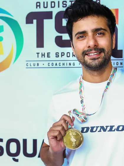 I lead from the front. Holding my own gold medal and winner's trophy from the TSH Squash Open. I bring my active pro-level experience to every player I coach.