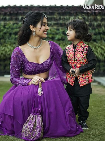 A heartwarming moment between mother and son. Jovan Veer Singh shines in his colorful printed Bundi, a perfect outfit for family celebrations.