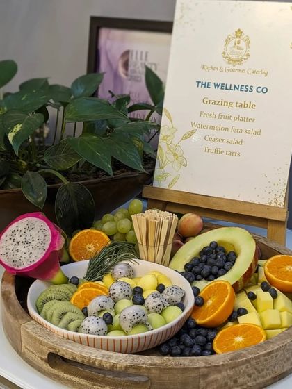 A vibrant and healthy fresh fruit platter created for The Wellness Co. This board is filled with exotic dragon fruit, kiwi, melon, blueberries, and oranges, promoting a message of well-being.