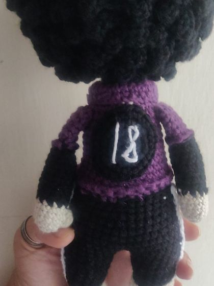 We also create custom character dolls. This is the back of a personalized doll, showing the custom jersey number requested by a client.