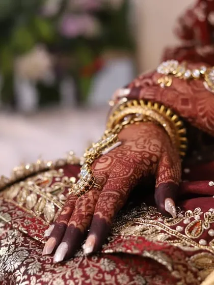Another angle of the bride's hands, showcasing the deep, rich color of her henna stain.