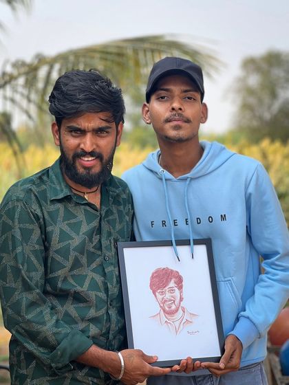 Here I am with Hanumanthanna, presenting him with the framed blood art portrait I created. His happiness and appreciation for my work mean the world to me.