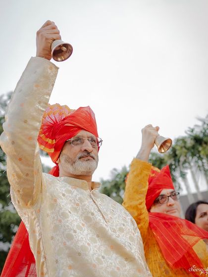 The fathers of the bride and groom ringing bells during the Maharashtrian wedding ceremony.