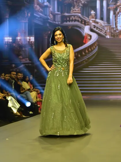 The full view of the Pine Green ball gown on the runway. This elegant gown is a beautiful option for a family member or a bride looking for a non-traditional color.
