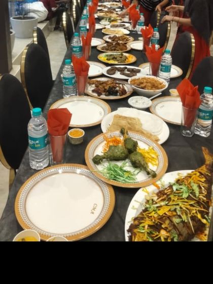 A view of the guest table setting, with starters and a whole grilled fish ready for the guests.