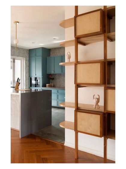 This modular shelving unit in the 'House of Skye' was designed with teak posts and birch ply shelves. The boxes can be rearranged, allowing the clients to adapt the display as they collect new objects and memorabilia.
