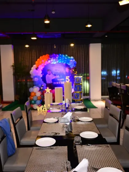 This image shows how my decoration setups look within a larger venue. Here, the space-themed birthday stage becomes the centerpiece of the restaurant party area.
