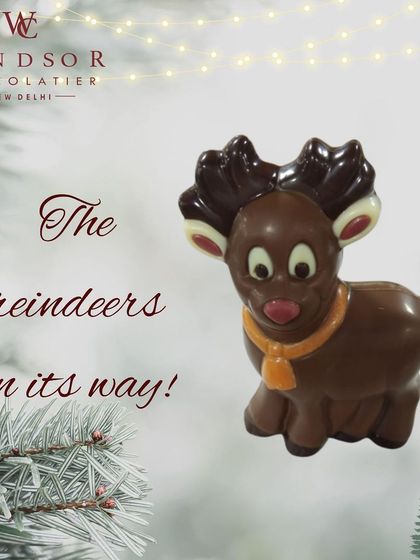 A cute and simple chocolate reindeer figure, detailed with wide eyes and a little bell collar, ready to guide Santa's sleigh.