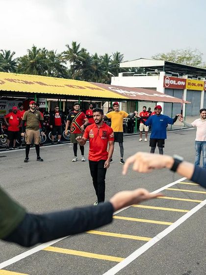 Fitness is a core part of our training. Here, participants engage in a fun warm-up session on the track before getting on their bikes.