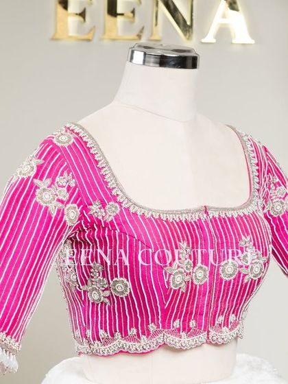 Pretty in pink, this raw silk blouse features intricate pearl and silver thread work in a striped pattern. I added floral motifs and delicate danglers on the sleeves for a touch of playful elegance.