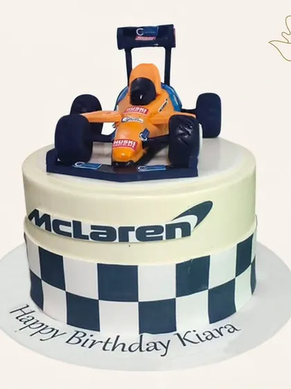 A high-speed McLaren Formula 1 cake. This design features the iconic race car and checkered flag pattern, perfect for a fan of the sport.