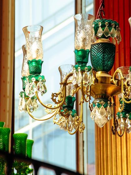 A close-up of one of our emerald green and crystal chandeliers. The combination of rich color and classic design adds to the timeless charm and glamour of the Khubani aesthetic.