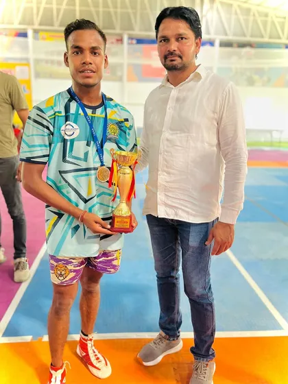 One of our standout players with the coach, holding the 2nd place trophy from the C.B.S.E. Nationals.