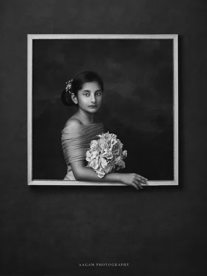 A creative, conceptual portrait of a child. By placing her within a frame, she becomes a living work of art, a beautiful reflection of the human spirit.