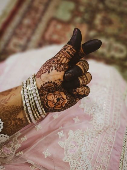 A playful pose showing off the dark, mature henna stain.