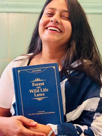A joyful moment with a book on Forest and Wild Life Laws. My passion for animal rights extends to all aspects of environmental and wildlife protection law.