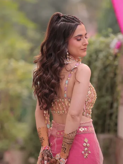 A view of the stylish braided ponytail. The hairstyle is just as important as the makeup for completing the look.