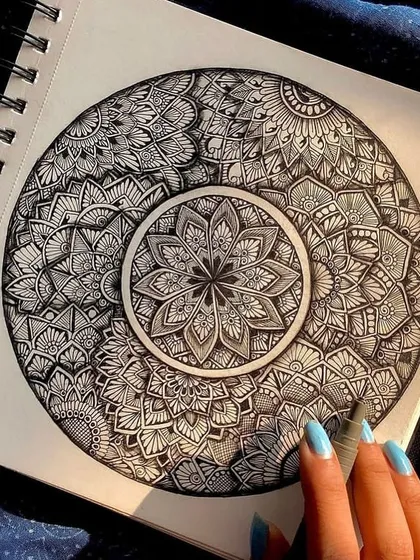 Lost in the details of an intricate black and white mandala. The process of filling a circle with patterns is incredibly calming and familiar to me.